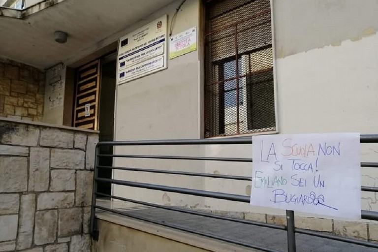 Cartello di protesta contro la decisione di Emiliano davanti a una scuola biscegliese